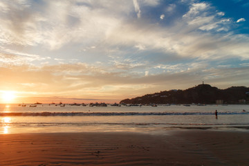 Sunset on a sea beach with fantastic sky clouds. Twilight reflection . San Juan del sur, Nicaragua