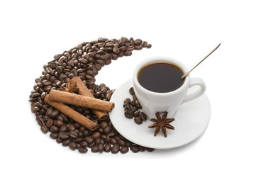 cup of coffee with cinnamon sticks, anise and chocolate
