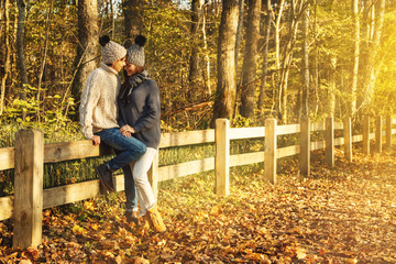 Young couple in the park at sunny autumn day