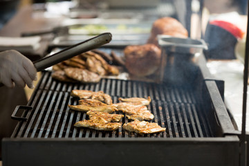 Sizzling Meat Being Cooked on a Barbecue Grill. Street food and bbq concept.