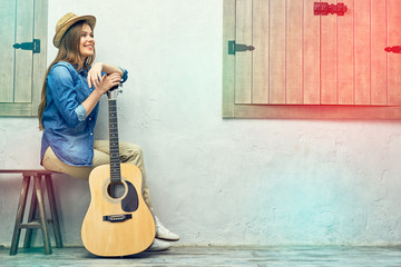 Portrait of smiling girl with  guitar.