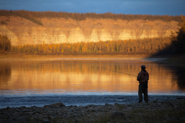 Fototapeta na wymiar Evening fishing on the Siberian river autumn