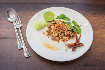 Spicy minced chicken salad on a wooden floor.
