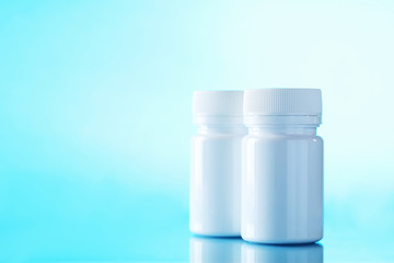 White cosmetic bottles on a blue background
