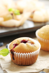 Muffins with blueberries on grey wooden table