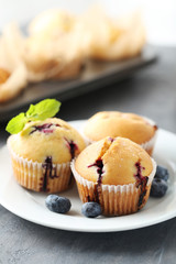 Muffins with blueberries on a grey table