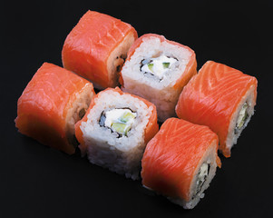 Set of Salmon rolls on a black background