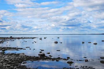 Calm stony bay with water reflections
