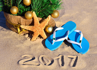 Christmas tree with christmas balls, slippers and starfish on th