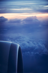 Airplane engine view from window with beautiful sky at sunrise during flight