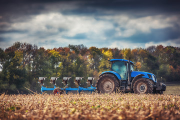 Farmer in tractor preparing land with seedbed cultivator