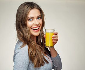 woman holding glass with orange juice smiling with teeth.