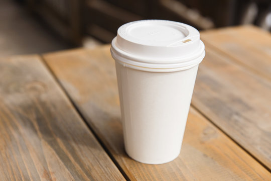 Take away coffee cup on a wooden table