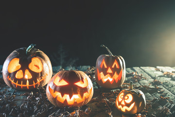 Halloween pumpkins at wood background.