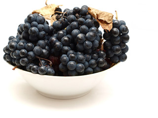 plate with grapes on a white background