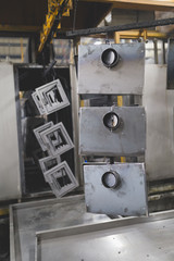 Metallurgy industry interiors. Details from factory for production of heavy pellet stoves and boilers. Sector for painting. 