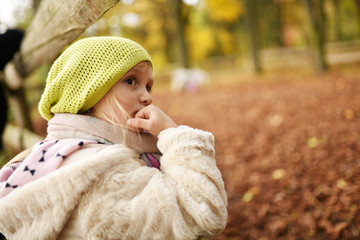  happy little girl laughing and playing in autum