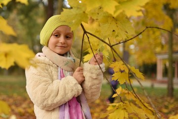  happy little girl laughing and playing in autum