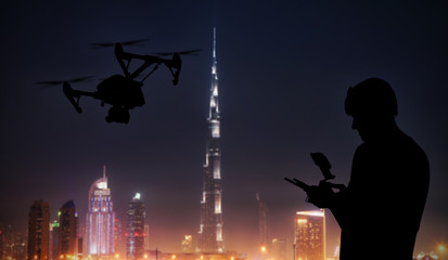 Man handling drone with modern city on background