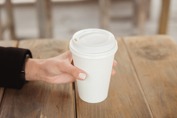 Hands with a take away coffee cup