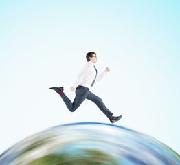 Businessman running on the globe