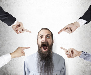 Shouting man with long beard being blamed
