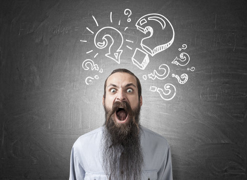 Shouting man and question marks on blackboard