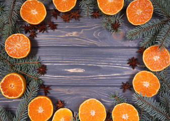Christmas background. Mandarins, gingerbread and Christmas tree branch on wooden BACKGROUND