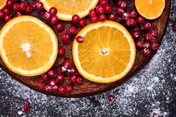 sponge cake with fresh oranges and berries on top
