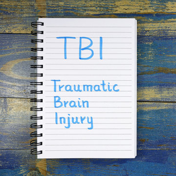 TBI- Traumatic Brain Injury Acronym Written In Notebook On Wooden Background