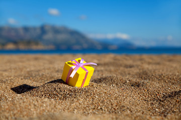 Fototapeta na wymiar Gift box on a beach