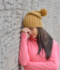 Close-up of a sad and depressed  woman deep in thought outdoors with copy space