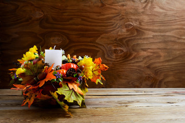 Thanksgiving decoration with silk leaves on rustic background