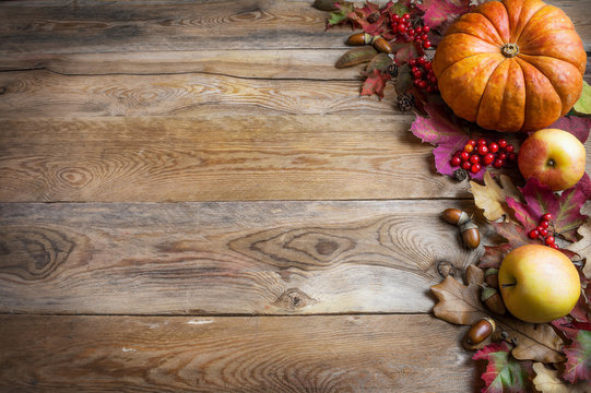 Thanksgiving or fall greeting with orange pumpkins, berries and