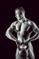 Fototapeta na wymiar Totally Naked muscular man covering with a kettlebell