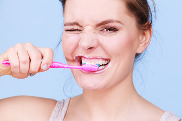 Woman brushing cleaning teeth