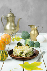 Healthy cabbage casserole at wooden table, still life, rustic style