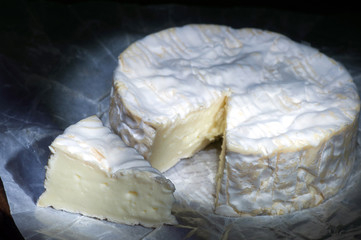 Wheel and segment of soft cheese camambert