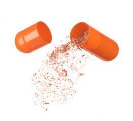 close up of open capsule isolated on white background