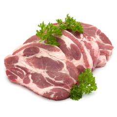 Raw pork neck chop meat with parsley herb leaves garnish isolate