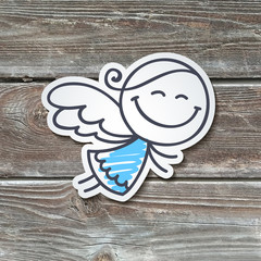 hand drawn angel, paper sticker on realistic wood texture