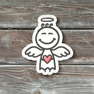 hand drawn angel, paper sticker on realistic wood texture
