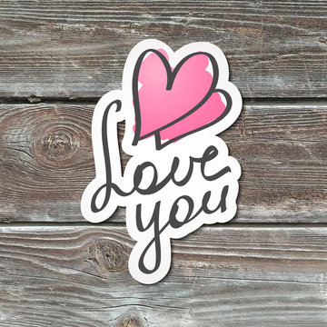 love you, handwritten text, paper sticker on realistic wood texture