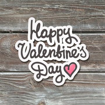 happy valentines day, handwritten text, paper sticker on realistic wood texture