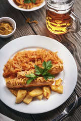 Baked Munich  sausages with stewed cabbage and a glass of beer