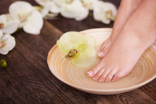Manicured female feet in spa pedicure procedure