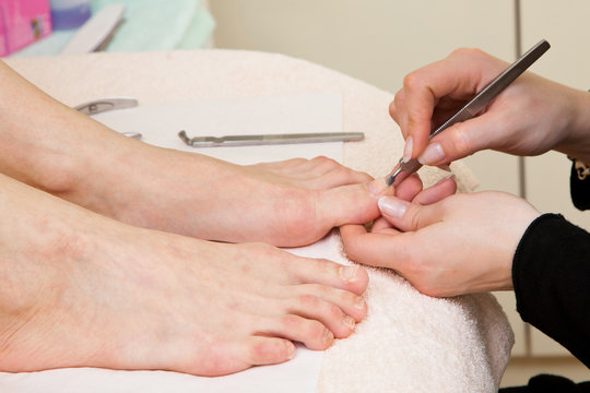 Pedicure process. Female feet closeup
