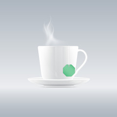 Cup of tea with tea bag on gray background