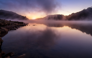 Fototapeta na wymiar morning sunrise on foggy lake