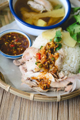 Delicious Hainanese chicken rice on wood background